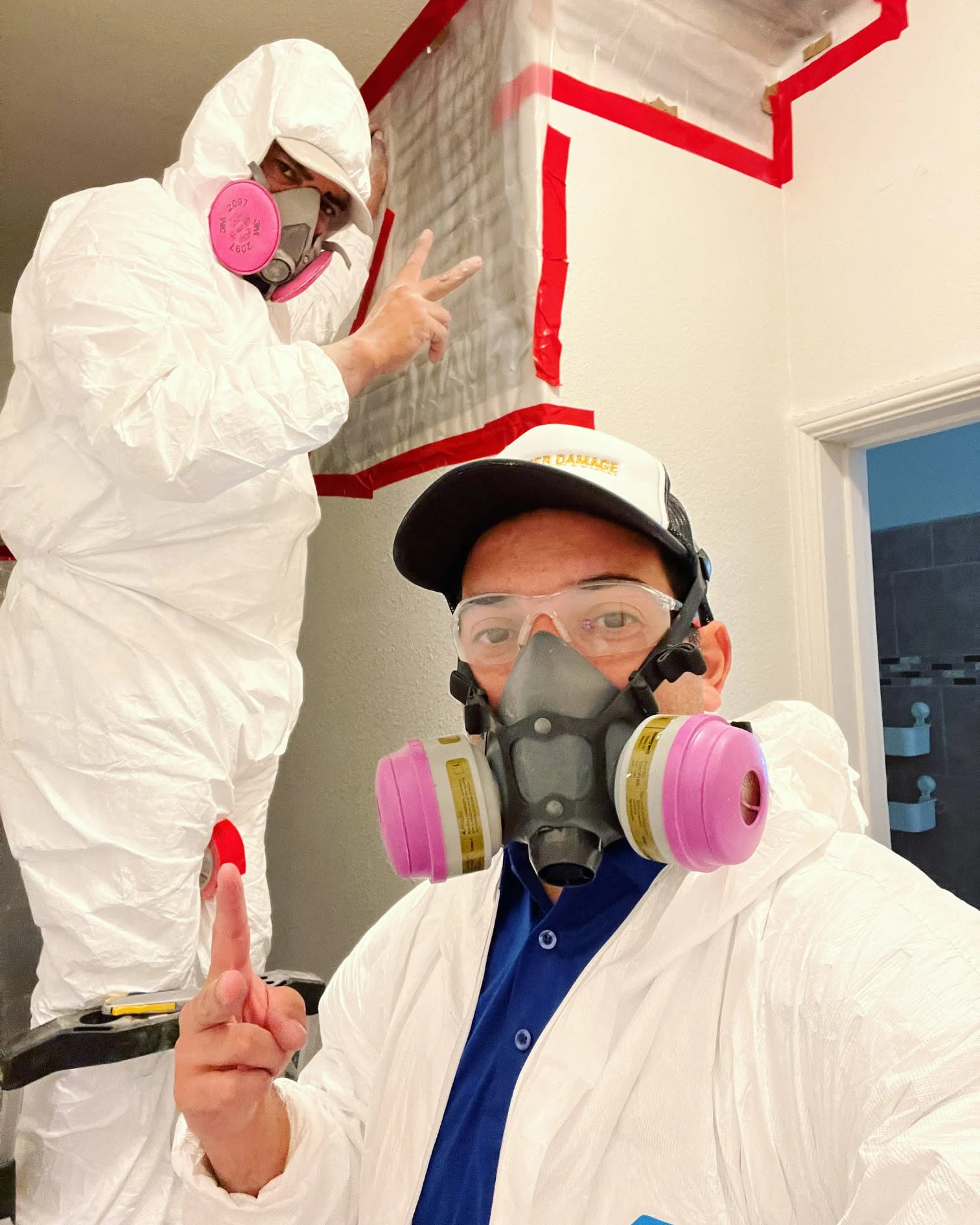 Mold remediation team working inside containment